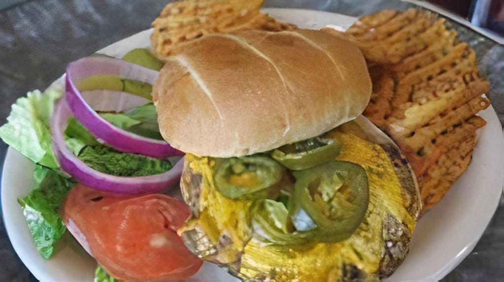 Jalapeno Burger · 1/3 pound black Angus burger seasoned with our signature spice, cooked to medium well and garnished with lettuce, tomato, onion, a pickle spear, and topped with jalapeño peppers and cheddar cheese.