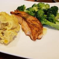 Grilled Salmon · Lightly marinated salmon, served with seasoned yellow rice and sauteed broccoli.