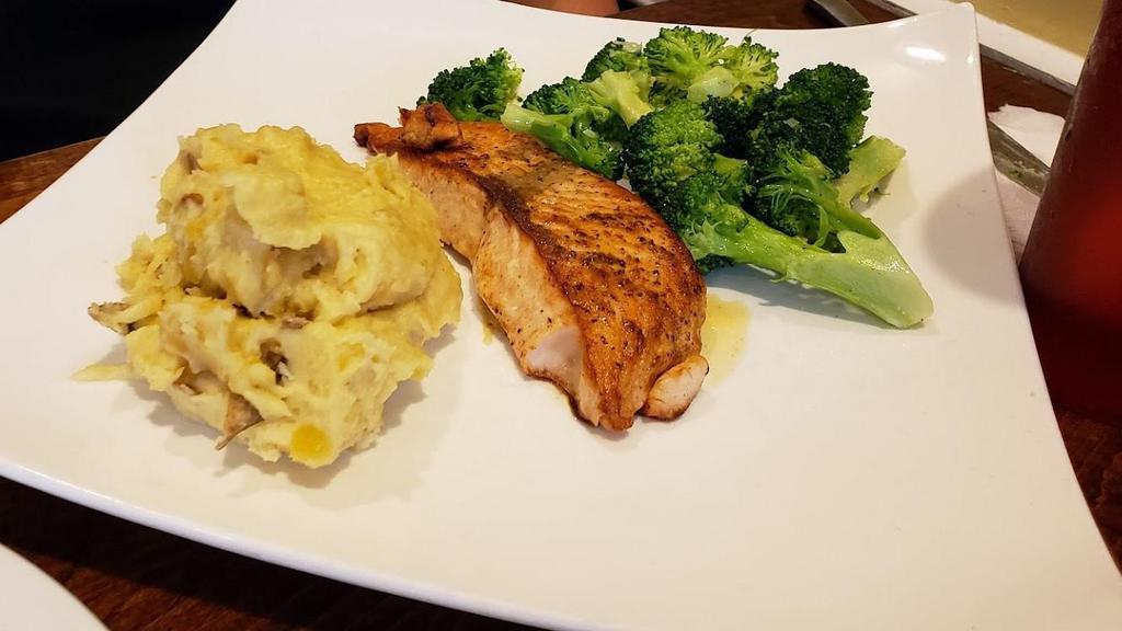 Grilled Salmon · Lightly marinated salmon, served with seasoned yellow rice and sauteed broccoli.