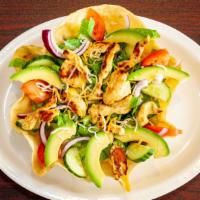 Chicken Avocado Salad · A crispy tortilla shell with lettuce, tomato, cucumber, grilled chicken breast pieces, avoca...