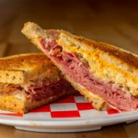 Reuben · Grilled corned beef with provolone and swiss cheese, sauerkraut, and Russians dressing on gr...
