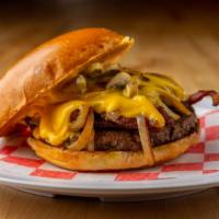 Cowboy Burger · Seven ounce angus beef patty topped with bacon, American cheese, grilled mushrooms and grill...