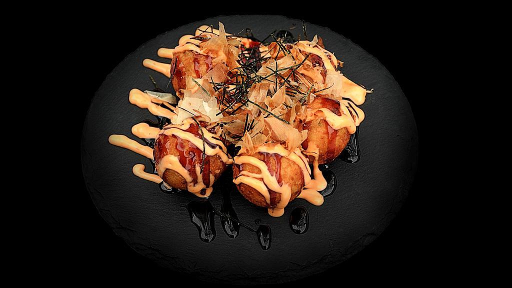 Takoyaki · Traditional Japanese octopus balls, top with eel sauce, spicy mayo, bonito flakes and seaweed - 6pcs