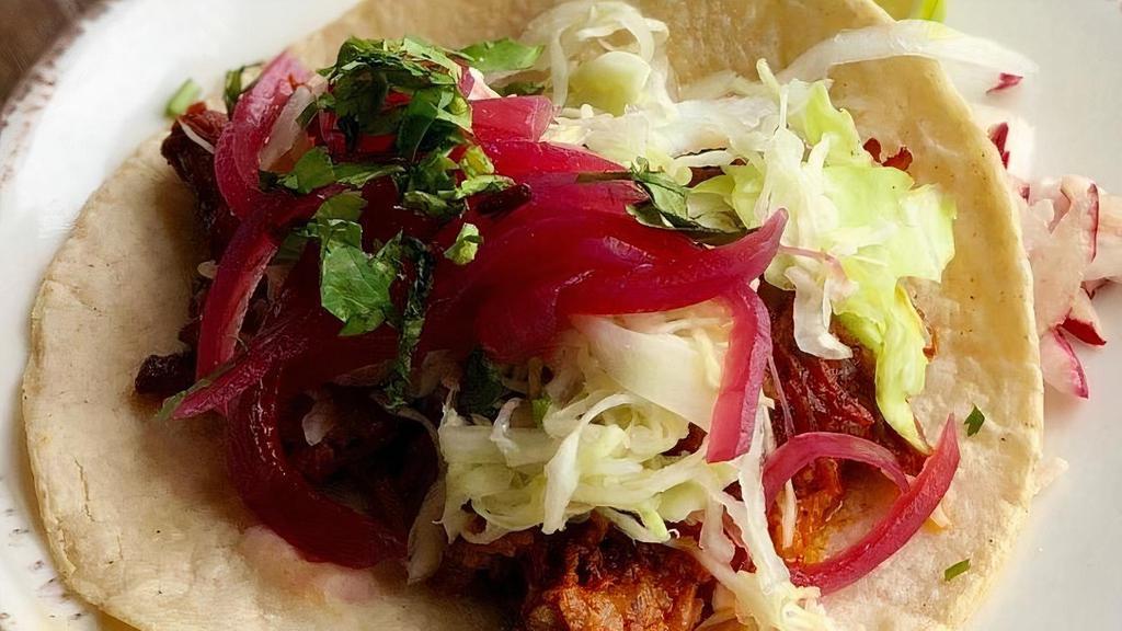Cochinita Pibil Tacos · YUCATAN-STYLE SHREDDED PORK | WHITE CABBAGE | PICKLED ONIONS | HABANERO | CILANTRO