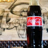 Mexican Coke · Classic Coca Cola made with real cane sugar! Bottle opener required to open. 12 fl. oz