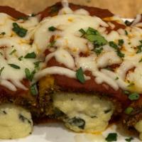 Eggplant Rollatini · Thinly sliced eggplant breaded and lightly fried with a ricotta cheese filling and baked wit...