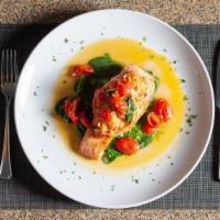 Salmone Ripieno · Salmon stuffed with crab meat, served over white wine sautéed spinach and cherry tomato sauce.