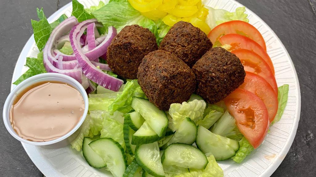 Falafel Salad · Includes lettuce, tomatoes, cucumber, banana peppers, and onion.