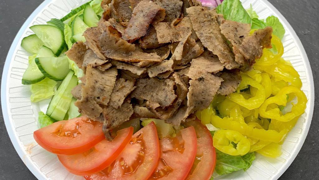 Beef Shawarma Salad · Includes lettuce, tomatoes, cucumber, banana peppers, onion and pickles.