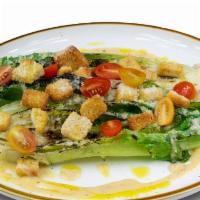 Caesar Salad (Grilled) · Grilled romaine lettuce and homemade croutons tossed with traditional Caesar dressing. Toppe...