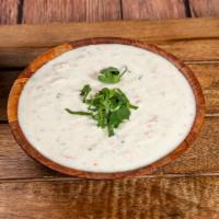 Raita · A side order of yogurt mixed with cucumbers, carrot & delicate spices.