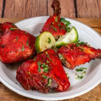 Chicken Tandoori · Two whole chicken legs marinated in yogurt, spices, herbs and barbecued in a tandoor. Served...