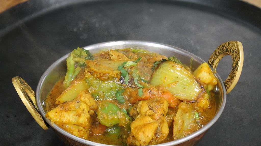 Chicken Jalfrezi · Boneless chicken cooked in butter with fresh slices of cauliflower, potatoes, carrots, green peppers, tomatoes, and onions.