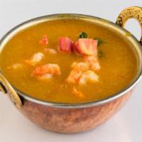 Shrimp Curry · A traditional south Indian entree. Shrimp cooked with onions, gravy with a touch of lemon.