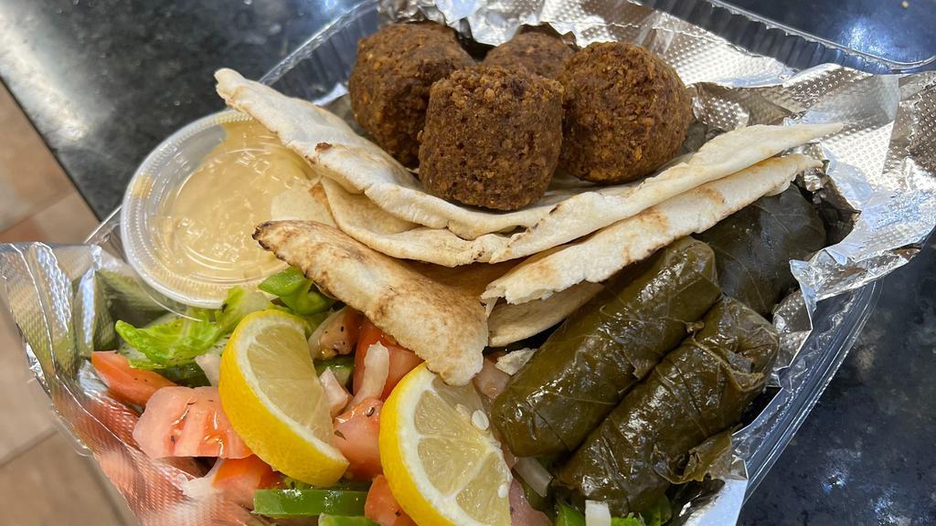 Falafel Platter · 5 pieces of falafel over greens w/ a side of tahini sauce and Pita.