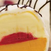 Exotic Bomba · Mango, passion fruit and raspberry sorbetto, all covered in white chocolate and drizzled wit...