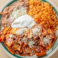 Chilaquiles · Two eggs served with rice beans jack and Cotija cheese with sour cream.