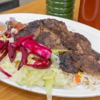 Costilla De Res (Beef Ribs) · Grilled beef ribs served with rice, beans, salad, avocado, and tortillas (2pcs). Costilla de...