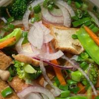 Vegan Pho · Fried tofu, broccoli, snow peas, bok choy, mushroom, carrot, red onion, green onion, and ric...