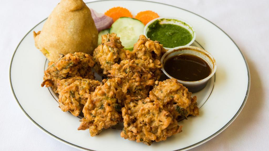 Assorted Appetizer · A combination platter with samosa and vegetable pakoras.