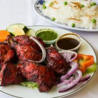 Tandoori Chicken · Chicken on the bone, marinated overnight in yogurt and spices then barbecued in the tandoor.