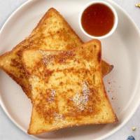 Timeless French Toast · Fresh bread battered in egg, milk, and cinnamon cooked until spongy and golden brown. Topped...
