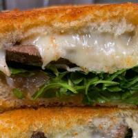 Steak Cheese · Swiss cheese melted with steak and topped with caramelized onions and arugula.