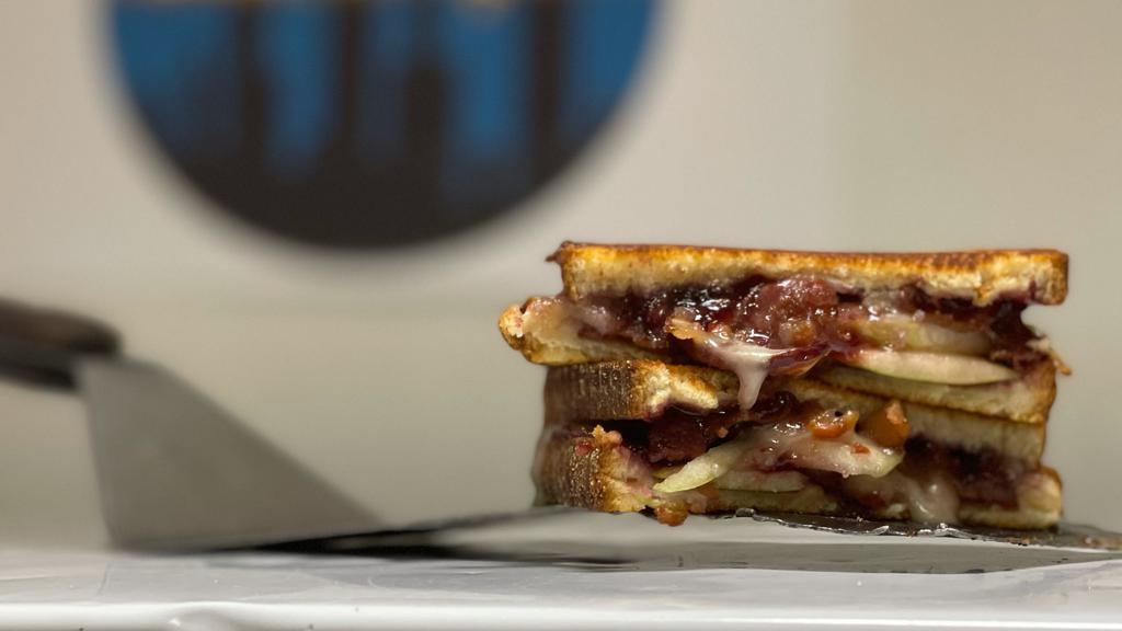 Sweet Cheese · Melted brie cheese topped with bacon, sweet jam, and sliced green apples.