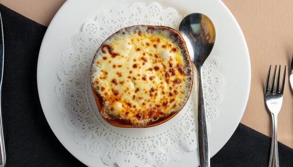 Three Onion French Soup · 3 onions, sherry wine broth, topped with seasoned croutons, imported Swiss cheese and mozzarella cheese.
