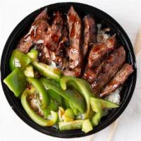 Spicy Pepper Steak · Spicy. Piled high with grilled steak and crisp green peppers, served over steamed rice and t...