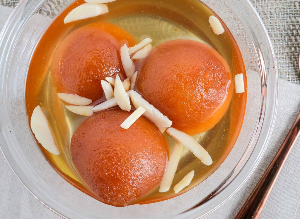 Gulab Jamun · Sweet golden dough balls drenched in syrup.