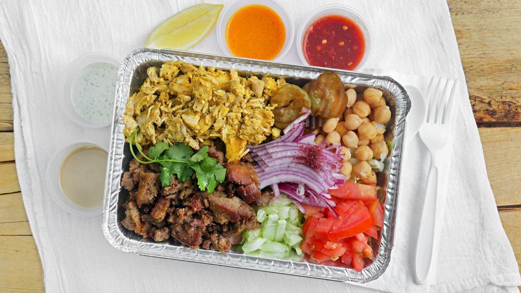 Combination Plate · Lamb and chicken with basmati rice, side salad, garbanzo chickpeas, pickles, red onion, lime slice, tahini, tzatziki sauce and hot sauce.
