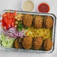 Falafel Over Rice · Falafel with basmati rice, side salad, garbanzo chickpeas, pickles, red onion, lime slice, t...