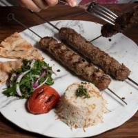 Kafta Kebabs · Ground lamb and beef, sumac, onion, garlic whip, rice.