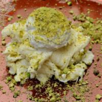 Halawet El Jibn · Sweet cheese topped with achta, pistachio,  rose water.