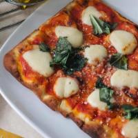 Margherita · pizza sauce, fresh mozzarella, basil, EVOO.