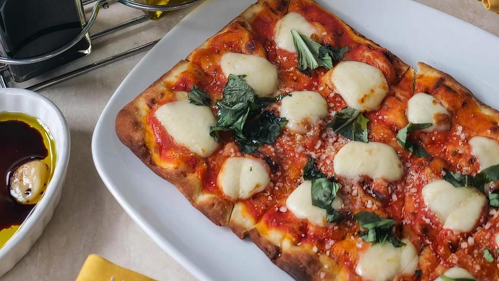 Margherita · pizza sauce, fresh mozzarella, basil, EVOO.