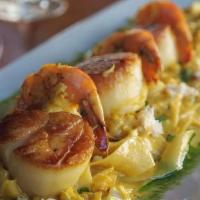 Pappardelle Allo Zafferano  · gulf shrimp, scallops, lump crab meat, saffron cream sauce.