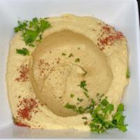 Plain Hummus · Mashed chick-peas blended with sesame paste (tahini), topped with olive oil and spices.