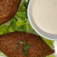 Kibbeh · Finely grounded meat and cracked wheat stuffed with seasoned sauteed meat, nuts and onions, ...