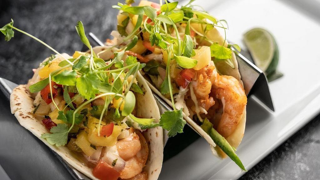 Shrimp Tacos · Marinated shrimp topped with coleslaw, lemon/garlic aioli and pineapple salsa.