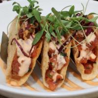 Tuna Taquitos · (3) Fried wonton tacos stuffed with Miso-Jang tossed ahi tuna, topped with a Korean slaw and...