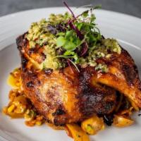 Grilled Half Chicken · Potato hash with corn, bacon, scallions, and tomato gravy. Chicken is topped with chimichurri.