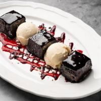 Flourless Chocolate Cake · Vanilla ice cream-blueberry & raspberry coulis-chocolate crumble