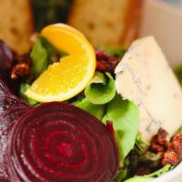 Roasted Beet Salad · Roasted red beets, mixed organic greens, gorgonzola, candied walnuts, capers and cabernet vi...