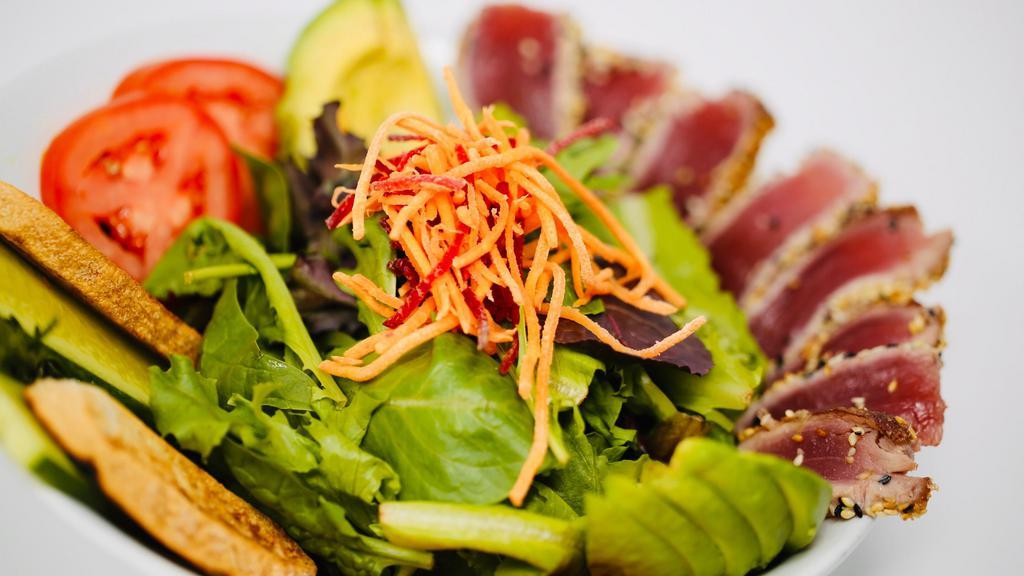Seared Ahi Tuna Salad · Mixed organic greens, avocado, tomatoes, Persian cucumber, shredded fresh carrots and beets and yuzu dressing.