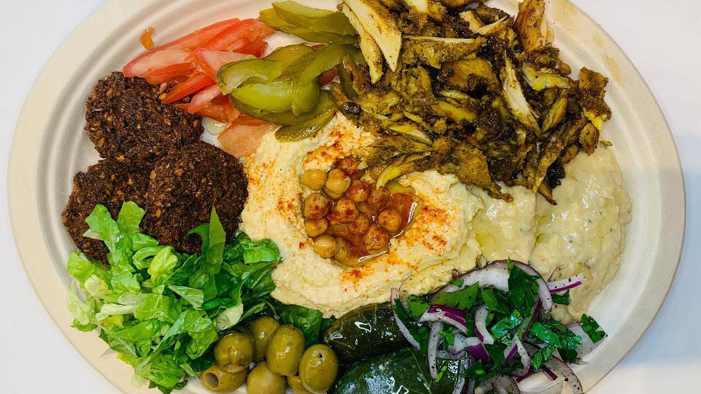 Mezze Plate · Hummus, baba ganoush, falafel, dolmas, tomatoes, olives, cucumbers,feta cheese, israeli pita bread. Add shawarma 2.95.