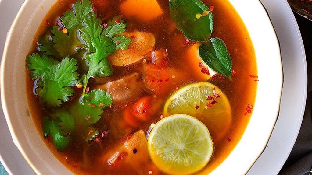 Tom Yum (Large) · Savory hot and sour soup with mushrooms, tomatoes, onions, lemongrass, galangal & lime leaves