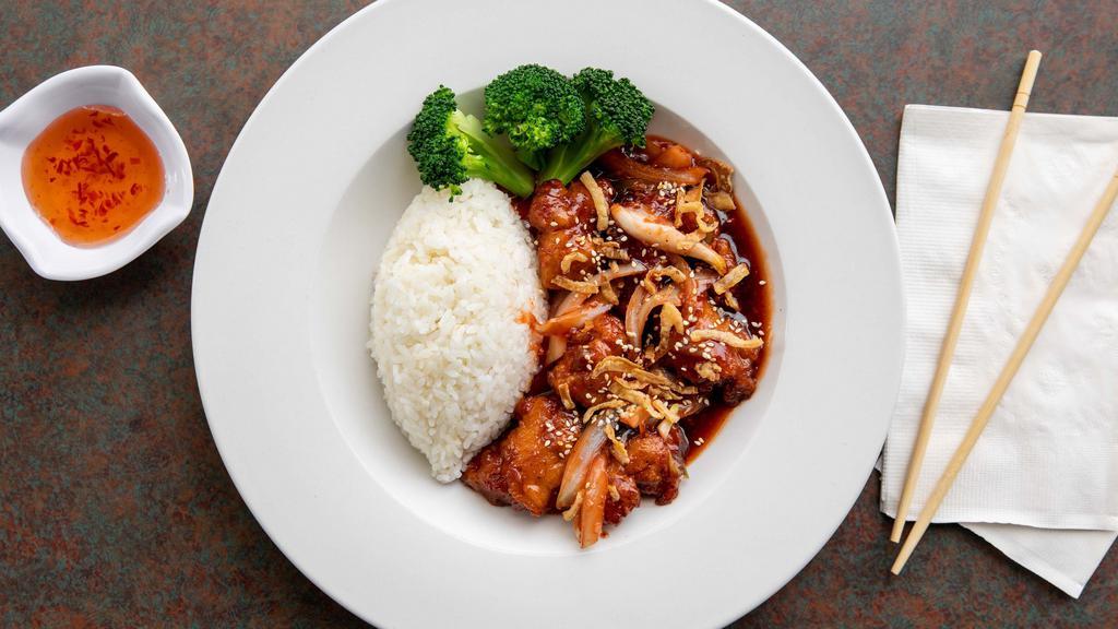 Tangy Chicken · Hand breaded chicken with onions coated in sweet and sour garlic sauce sprinkled with sesame seeds along with steamed broccoli
