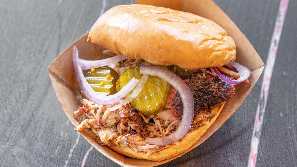 Signature Sandwich · Toasted bun, raspberry pepper jelly, red onions, pickles. Choice of meat: brisket, andouille sausage, pulled pork, or chicken.
